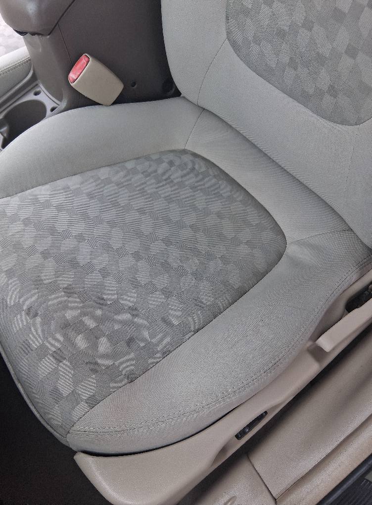 Clean car seat upholstery after professional interior detailing showing restored fabric at Diamond Auto Spa