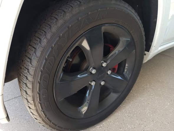 Dirty vehicle wheel and tire before professional detailing service at Diamond Auto Spa