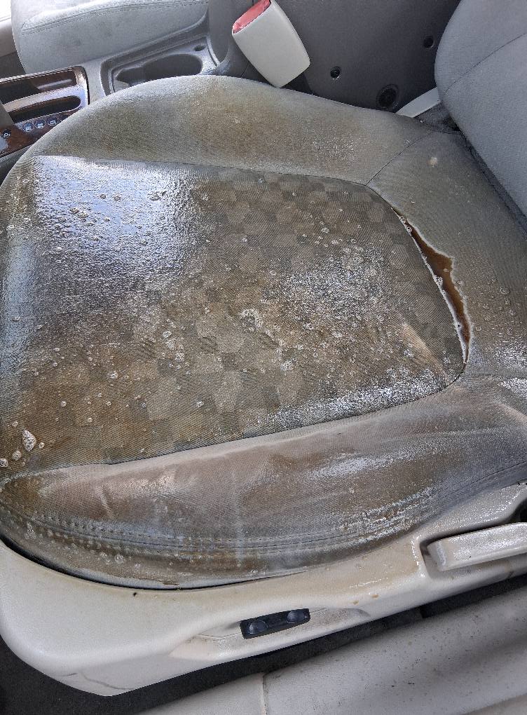 Dirty car seat upholstery with stains before professional auto detailing service