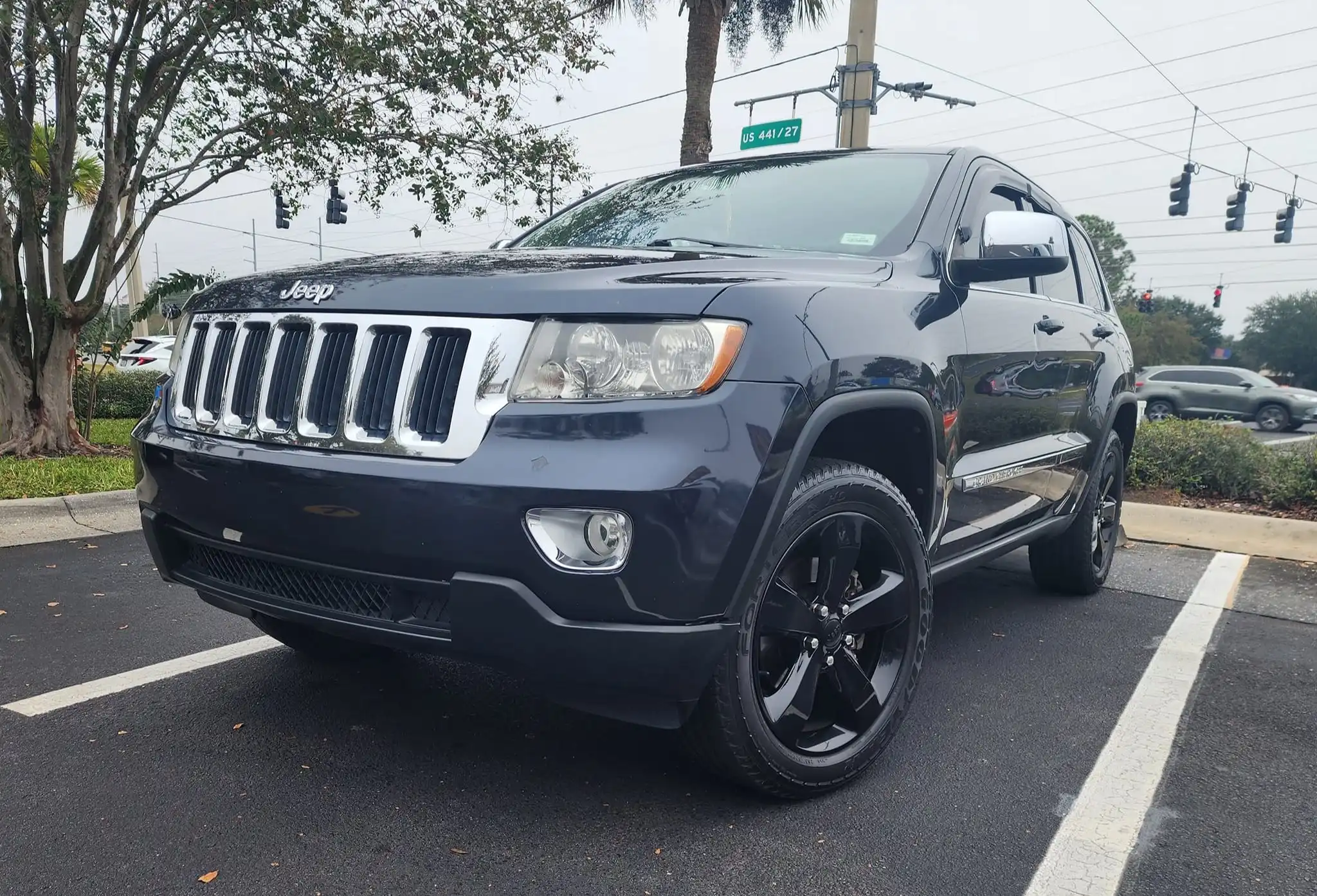 Jeep Grand Cherokee exterior detailing with black wheels and professional auto spa cleaning services