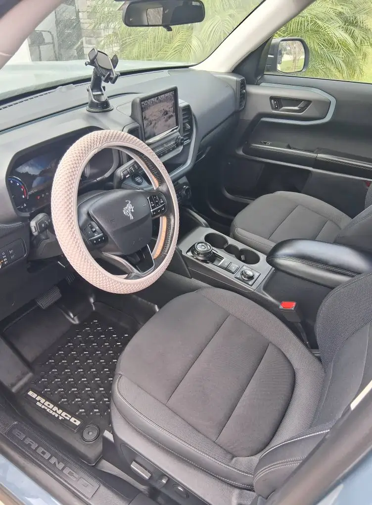 Detailed Ford Bronco Sport interior featuring cleaned fabric seats and a conditioned steering wheel