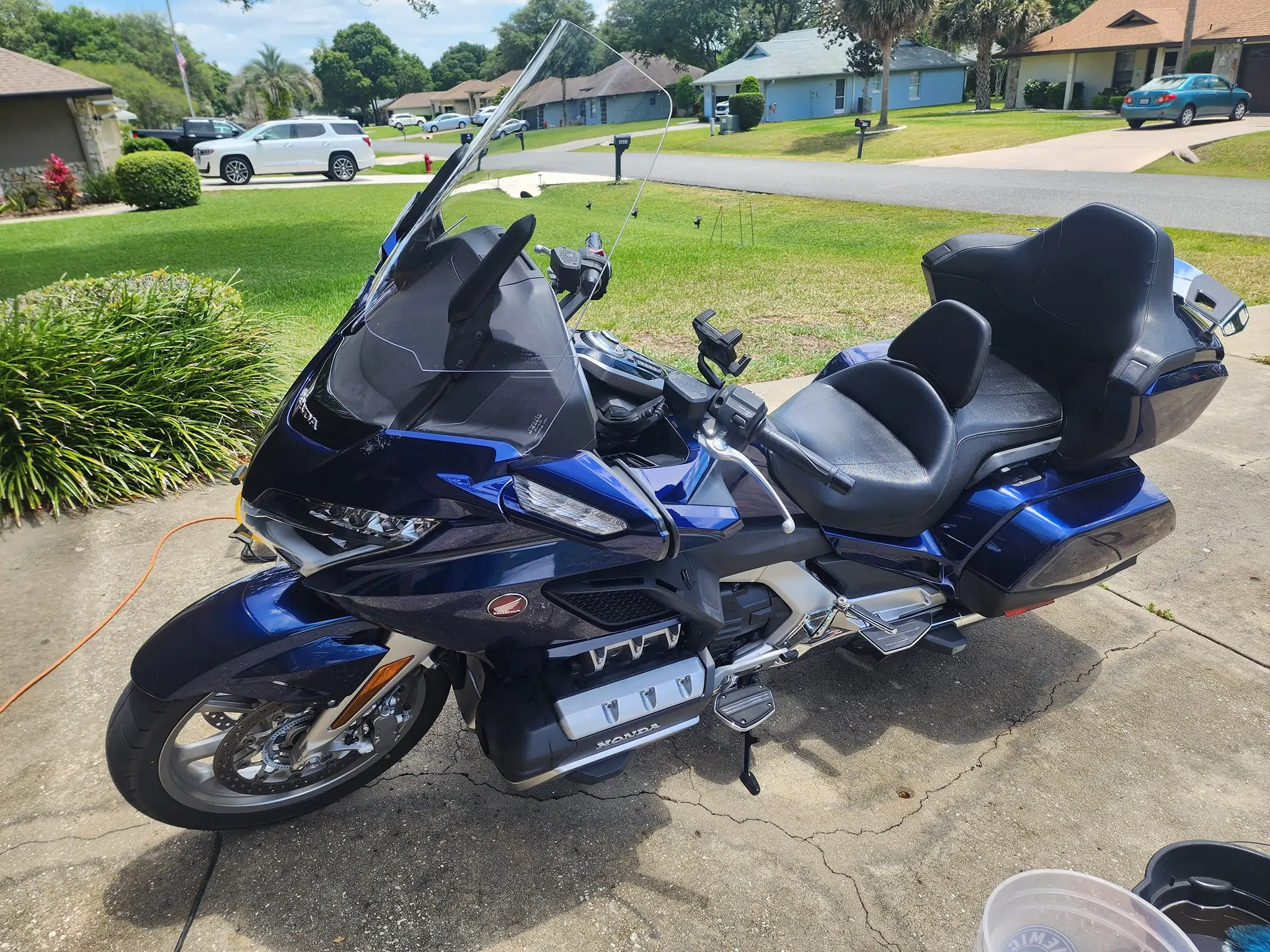 Professional detailing for a metallic blue Honda Gold Wing touring motorcycle including paint polishing and seat conditioning