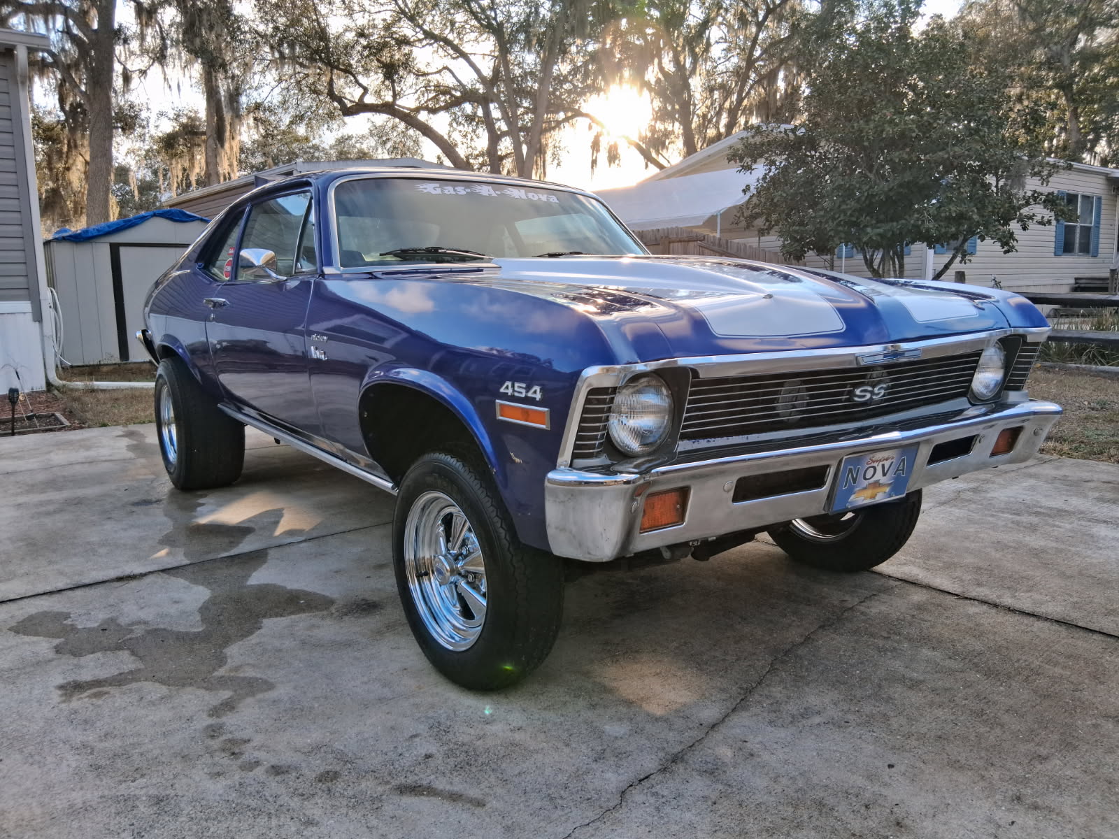 Professional detailing on a classic blue Chevy Nova SS 454 muscle car with chrome wheels and polished chrome bumpers