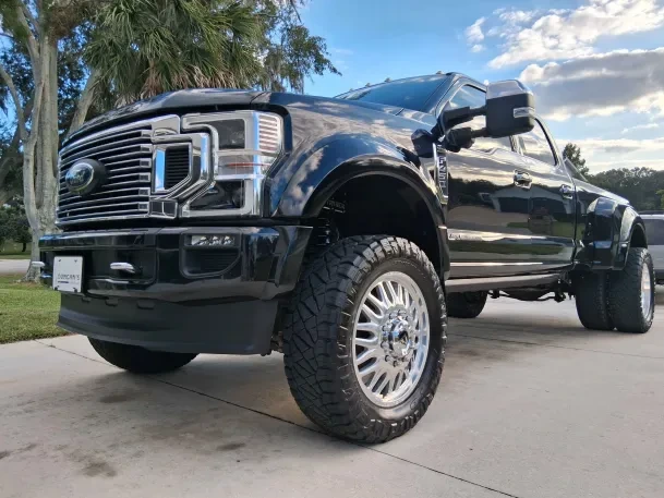 Luxury truck front grille detailing and exterior wash services at professional auto spa