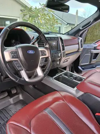 Red GMC Canyon professional exterior detailing with ceramic coating and wheel cleaning services